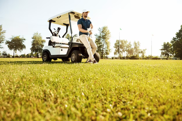 Young man relaxing leaning on a golf cart